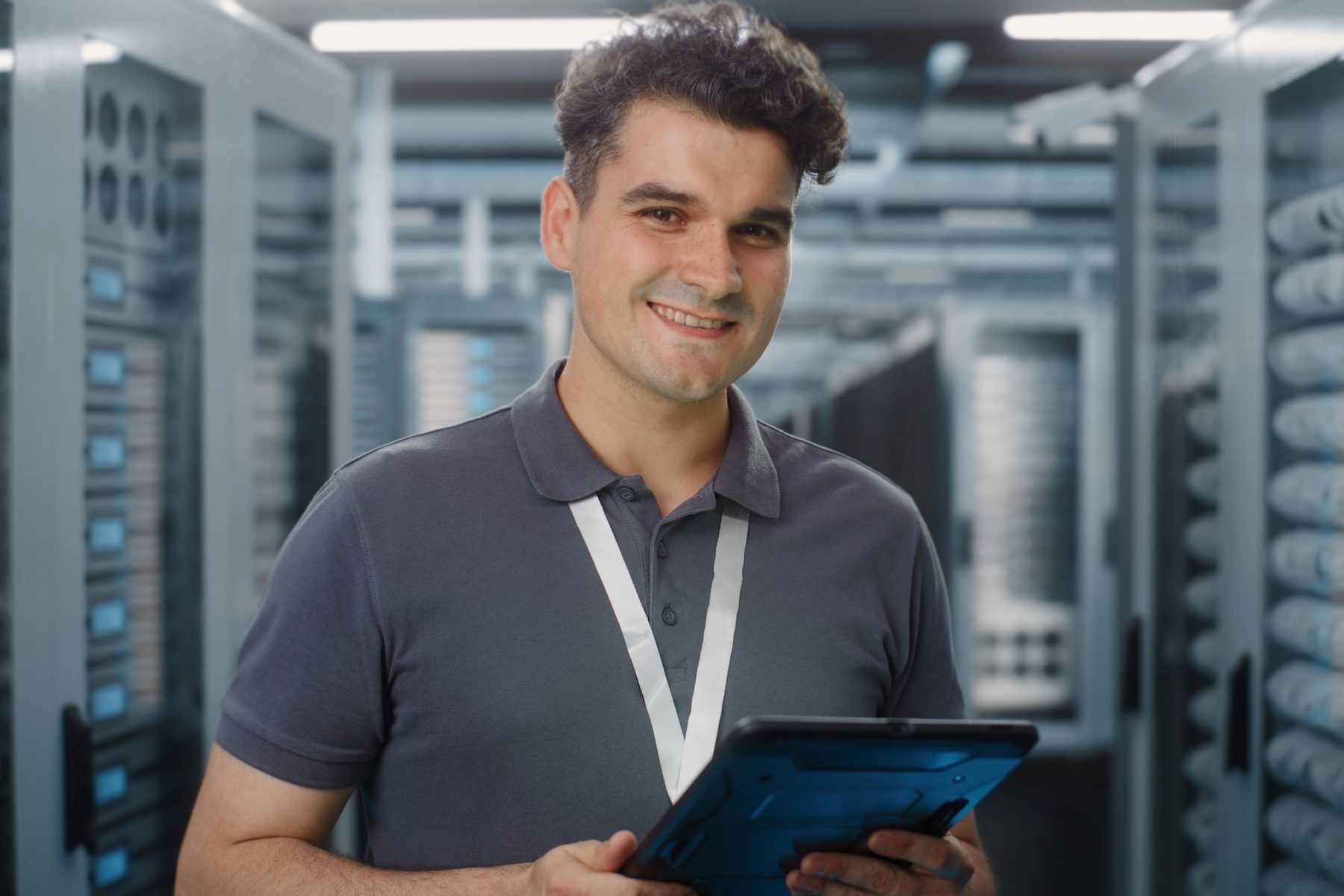 A technician checking equipment in a server room